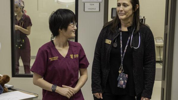 a woman standing next to a woman wearing scrubs, health sciences admissions