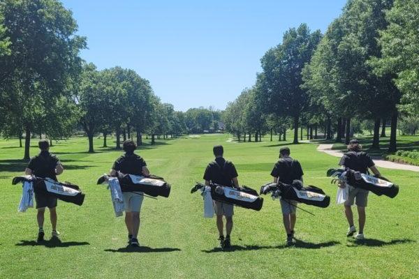 a group of people carrying golf clubs